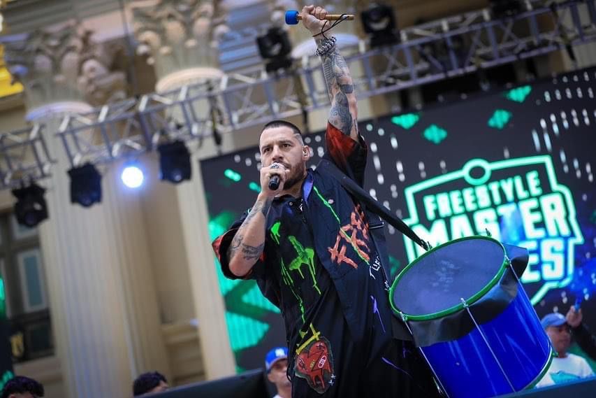 “Freestyle Master Series” had EXTi write a theme song for their 1st round live show at El Salvador, and design the outfit for his host and mc “Misionero”, to it.